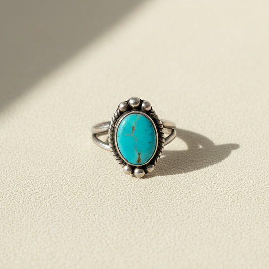 Turquoise oval cabochon ring with silver-tone bezel and bead accents