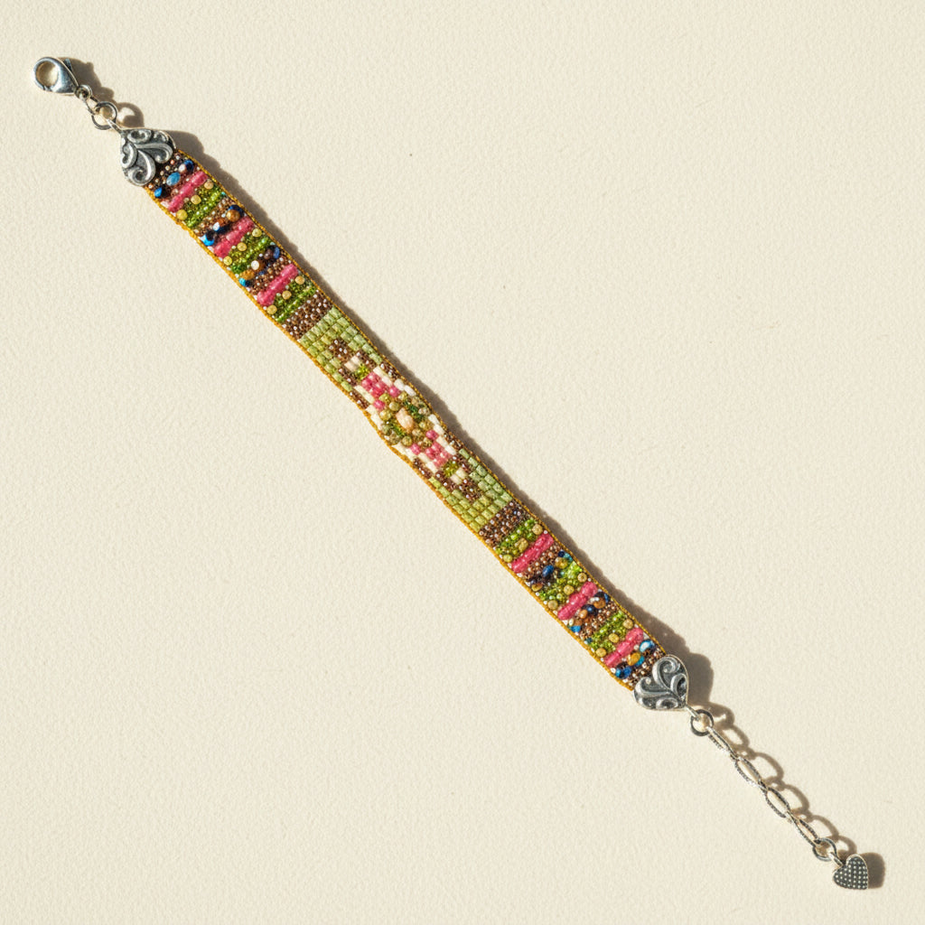 Multi-color beaded bracelet with silver-tone clasp and dangling charm