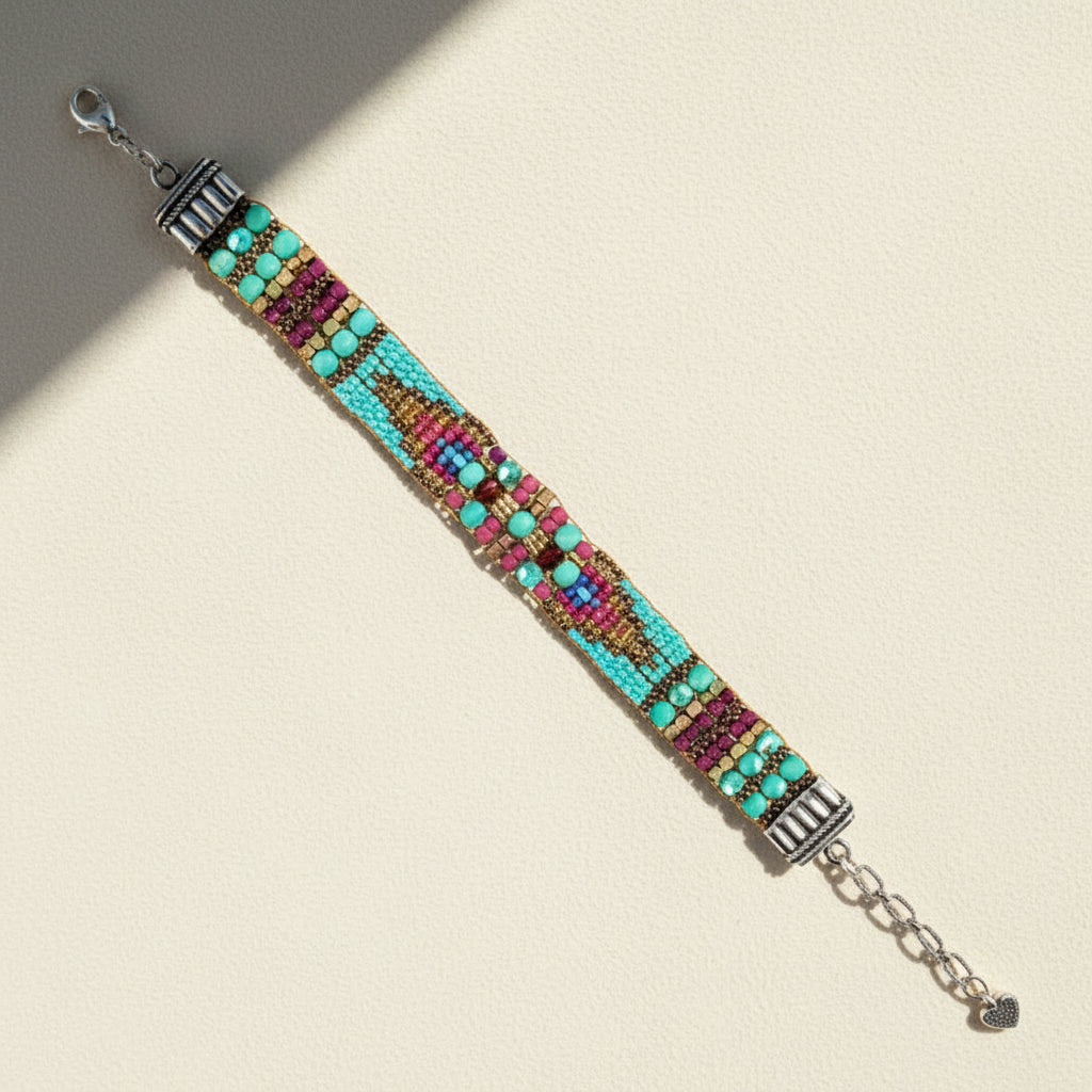 Multicolored beaded bracelet with metal clasp on a white background