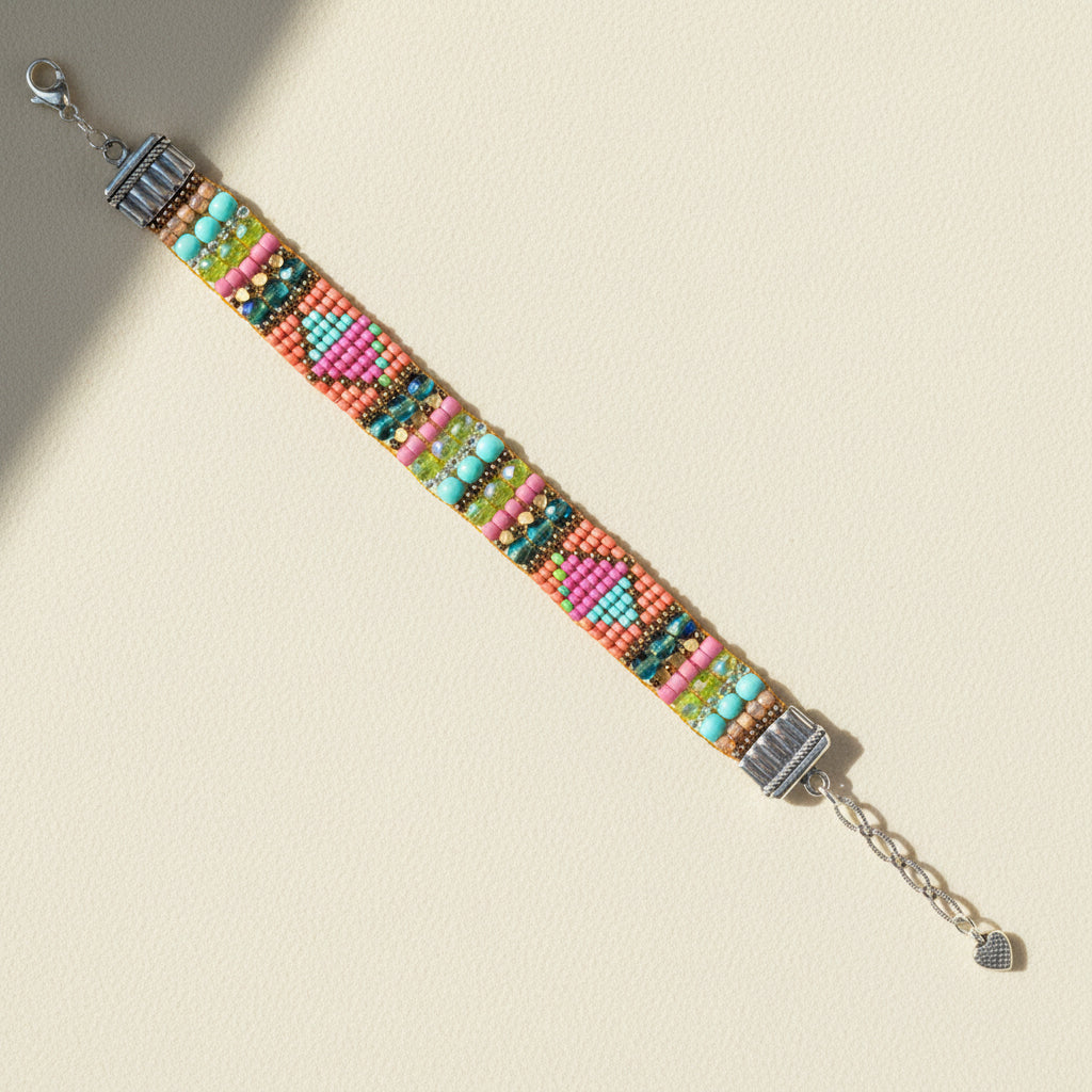 Beaded multi-color bracelet with silver chain ends and small charm