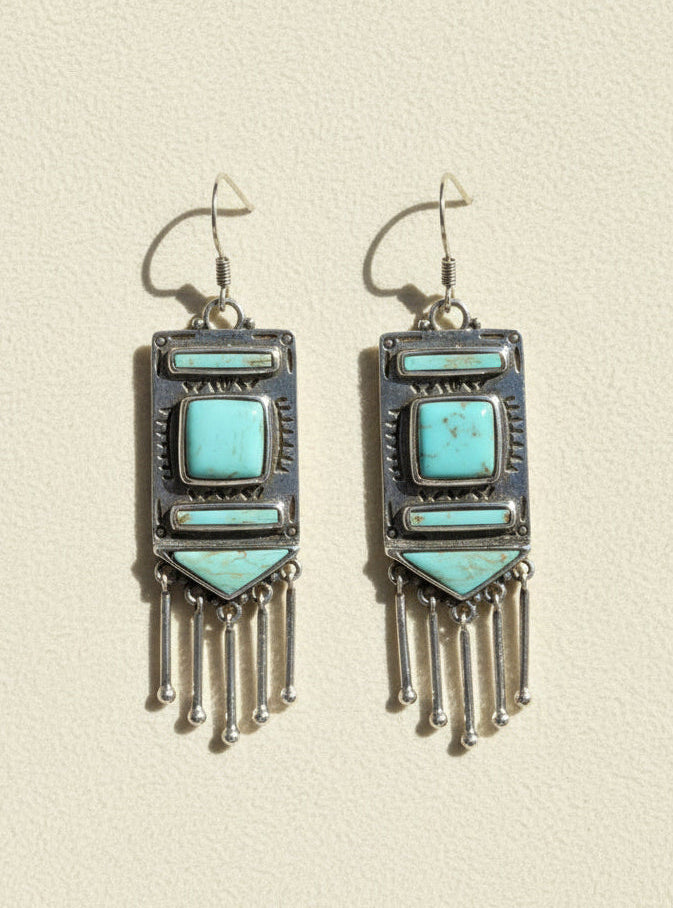 Turquoise stone chandelier earrings with silver-tone frames and dangling fringe