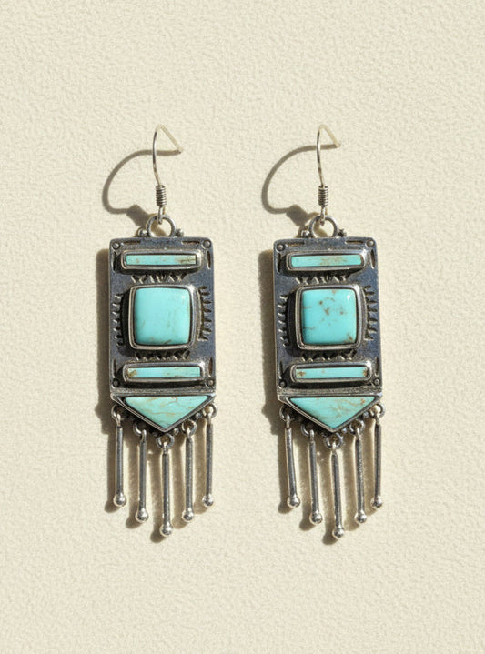 Turquoise stone chandelier earrings with silver-tone frames and dangling fringe