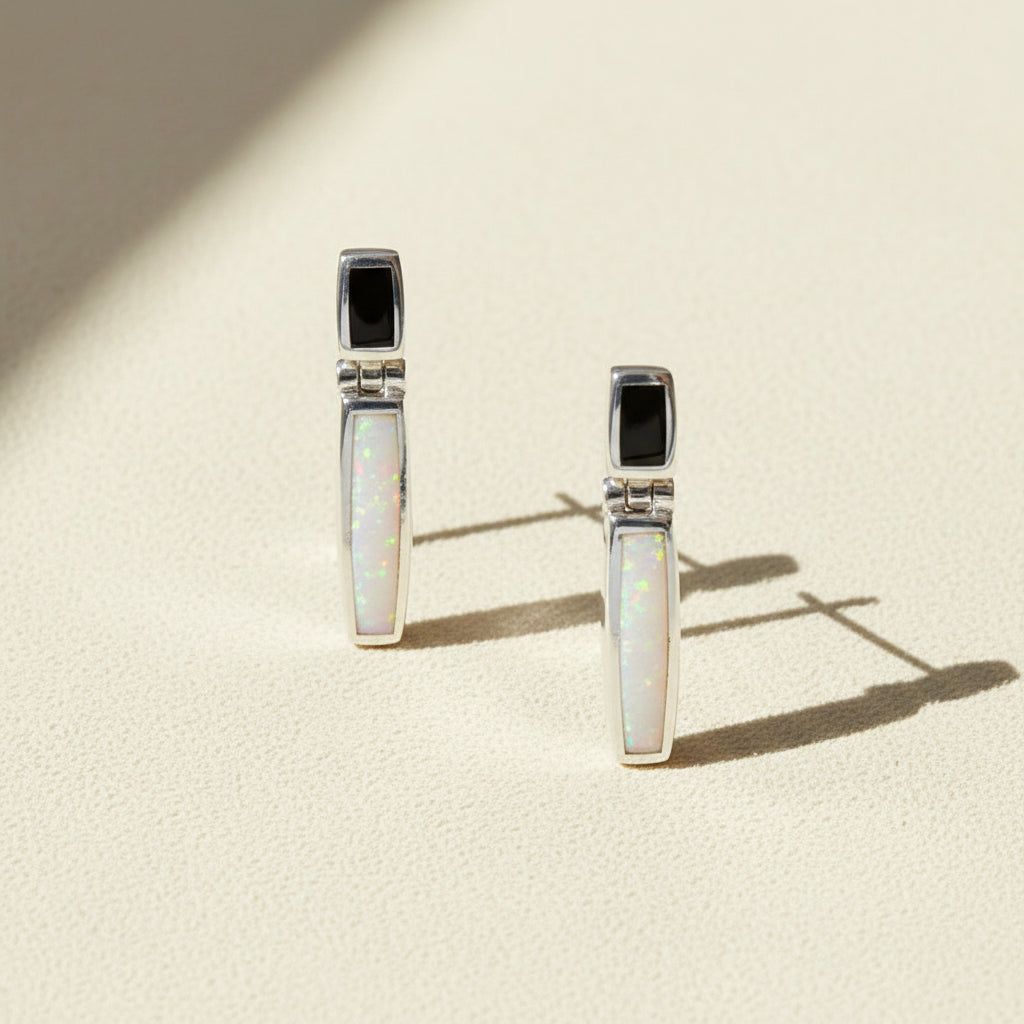 Pair of earrings with opal stones on a white background