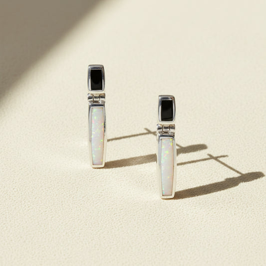 Pair of earrings with opal stones on a white background