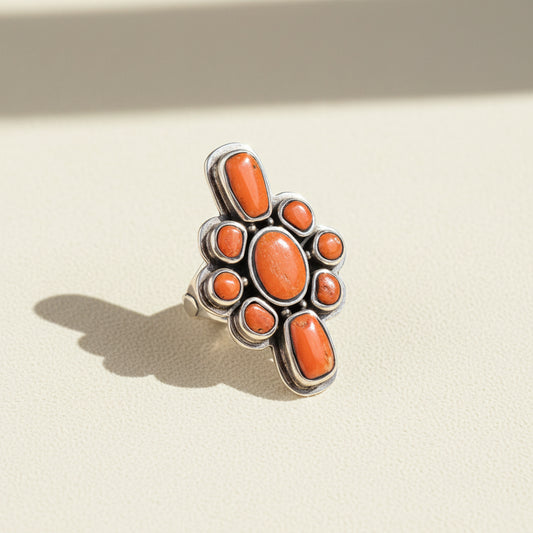Orange oval and round gemstone cluster ring in silver-tone setting
