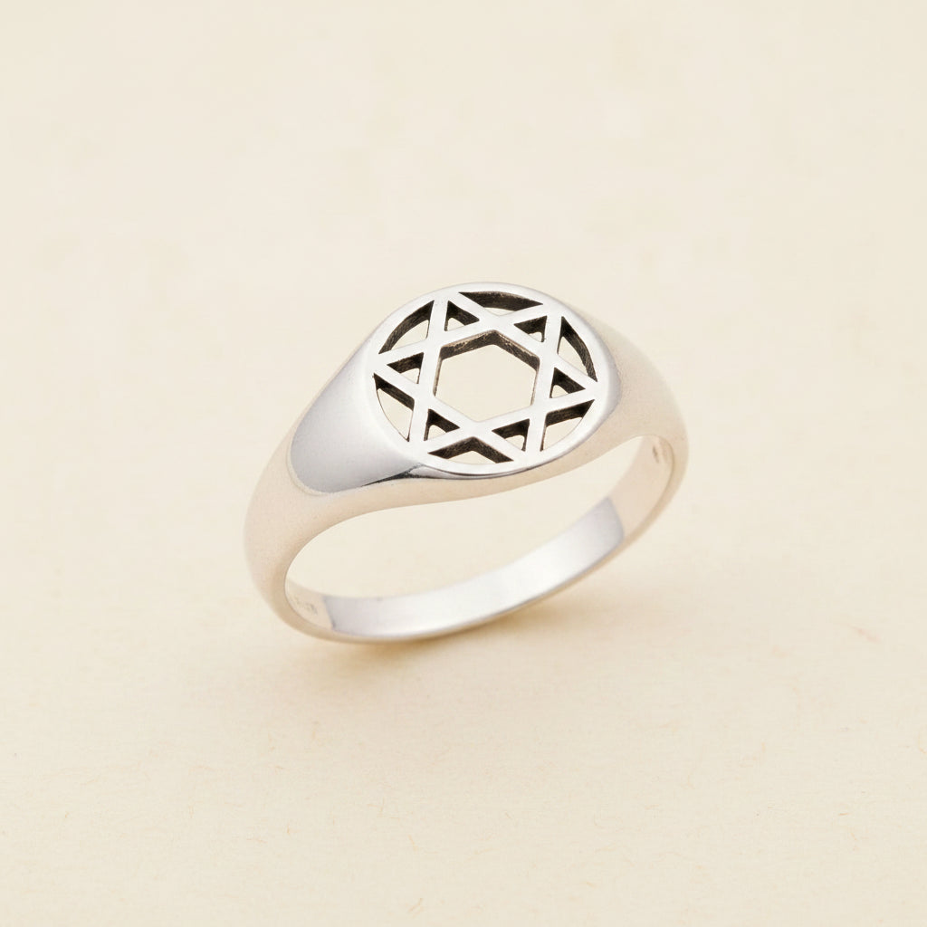 Sterling silver tone signet ring with engraved geometric star motif top