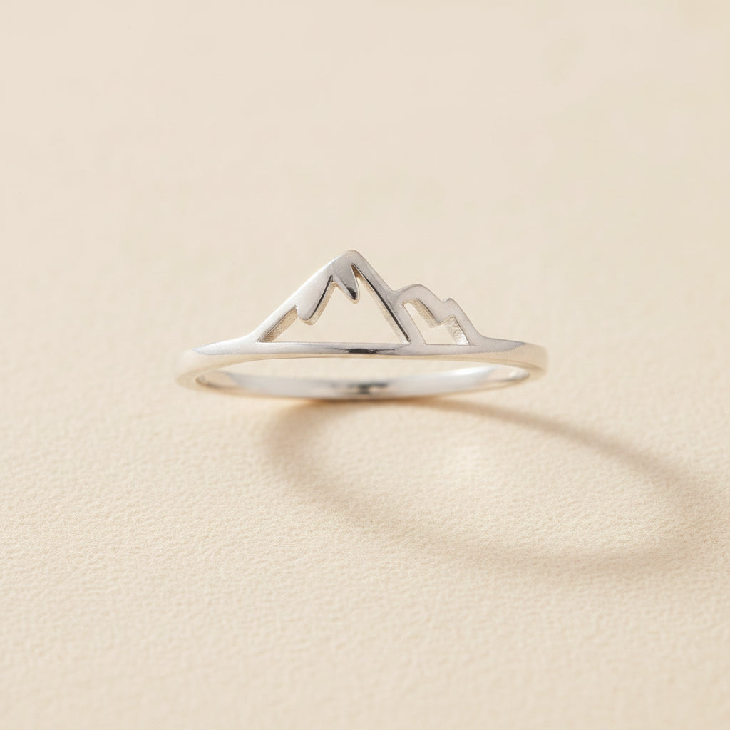 Silver mountain ring with raised peak and snowcap design