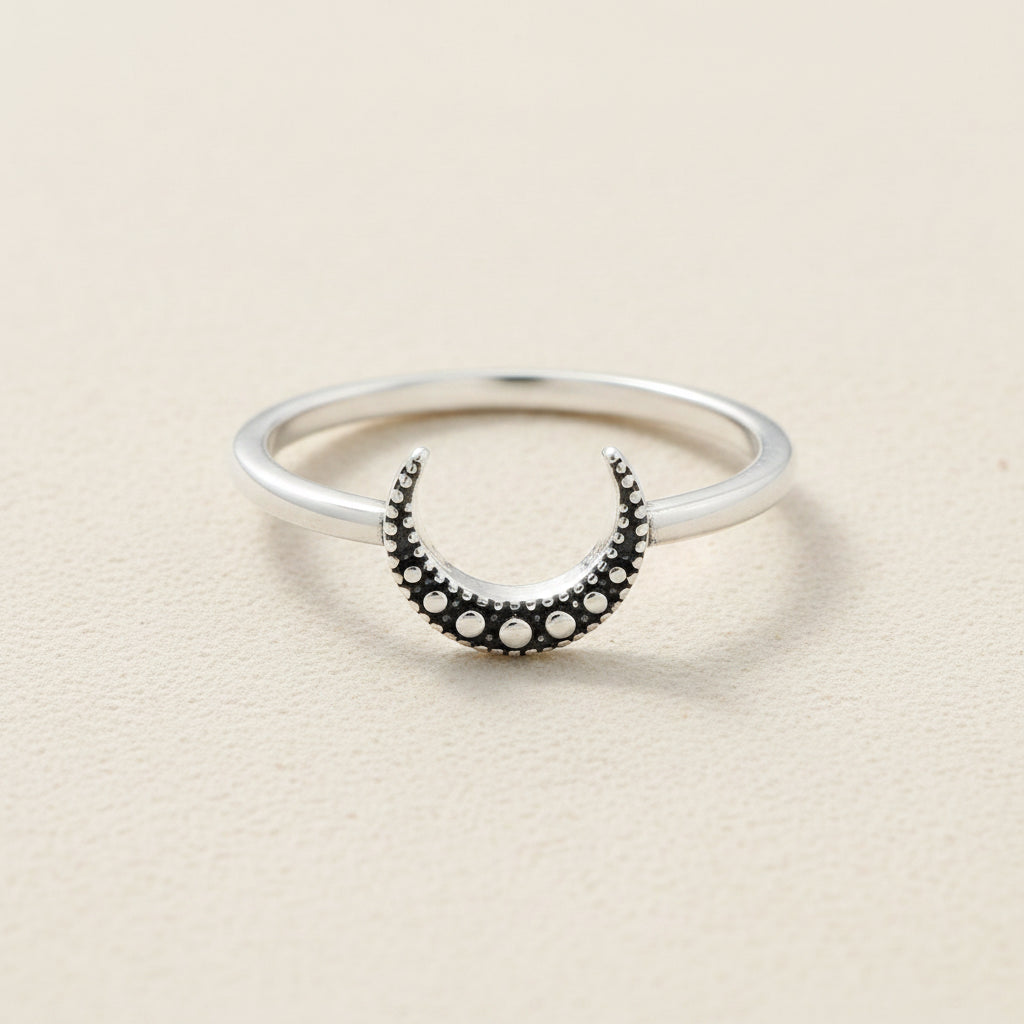 Silver ring with black crescent moon and round dot accents