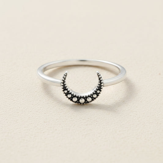 Silver ring with black crescent moon and round dot accents