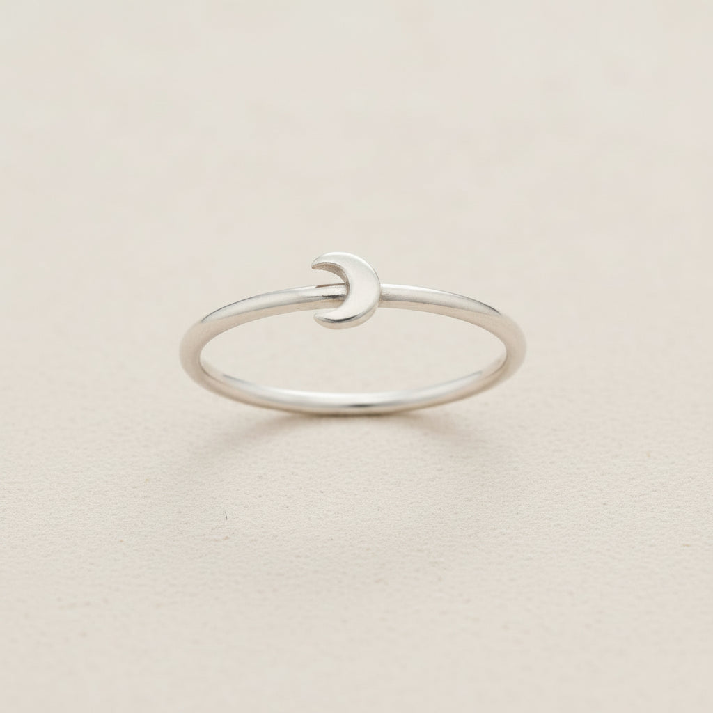 Silver crescent moon ring with smooth open band and small moon-shaped front detail
