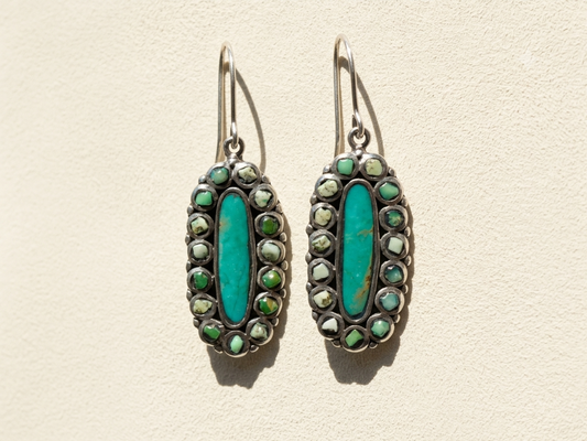 Turquoise oval hoop earrings with green and silver-tone bead accents