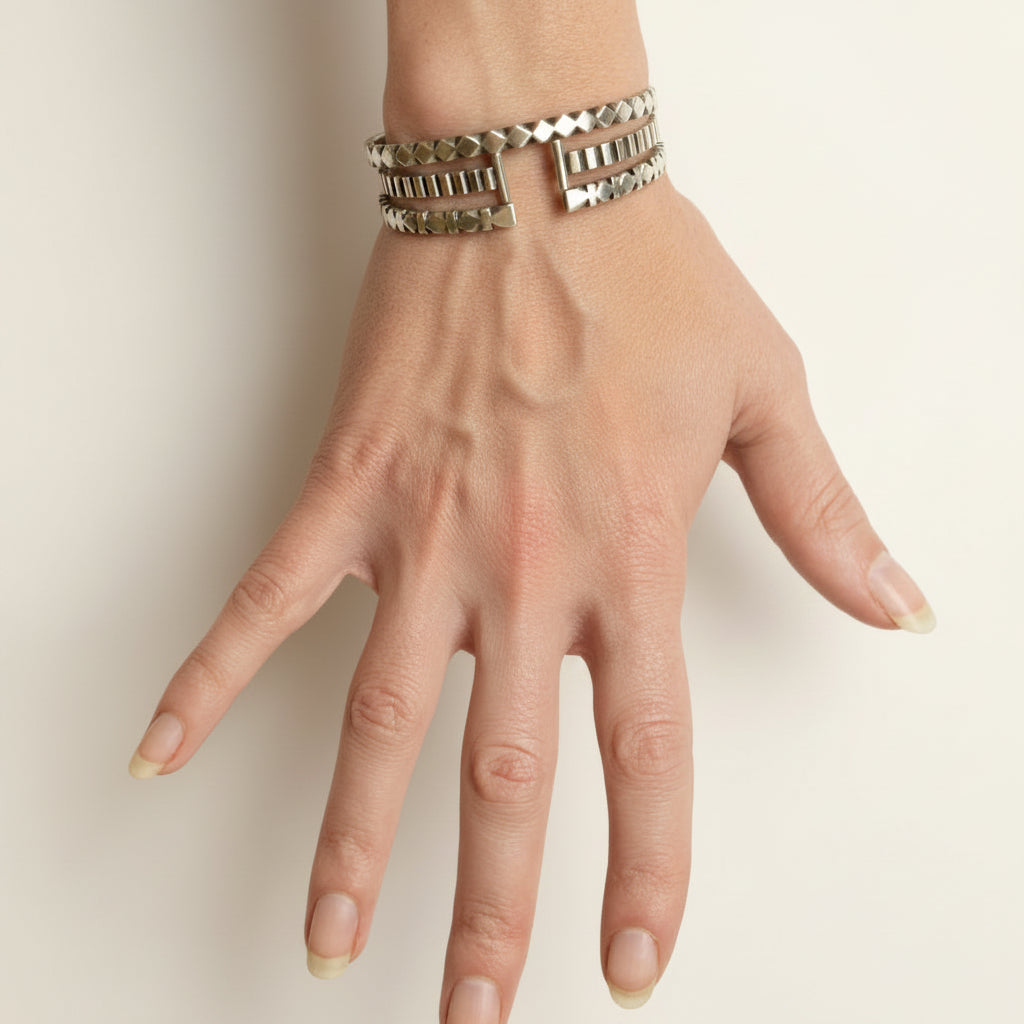 Hand-carved black-and-white diamond stripe cuff bracelet on wrist