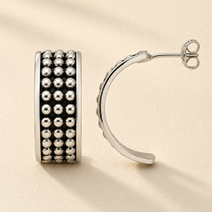 Silver beaded half-hoop post earring with rows of shiny round beads