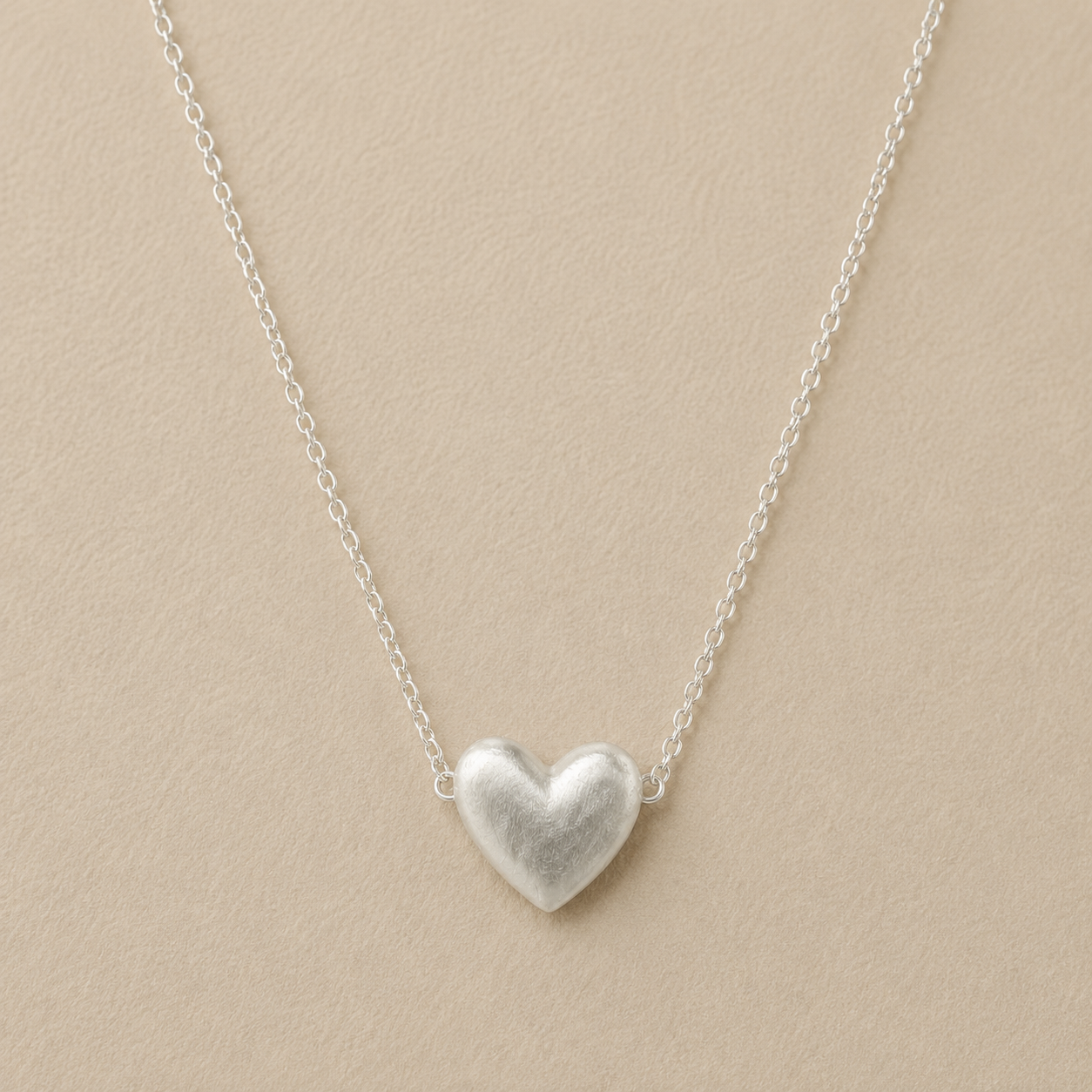 Silver-tone heart pendant necklace on a fine chain