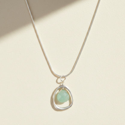 Silver open-circle necklace with teardrop pale green chalcedony pendant