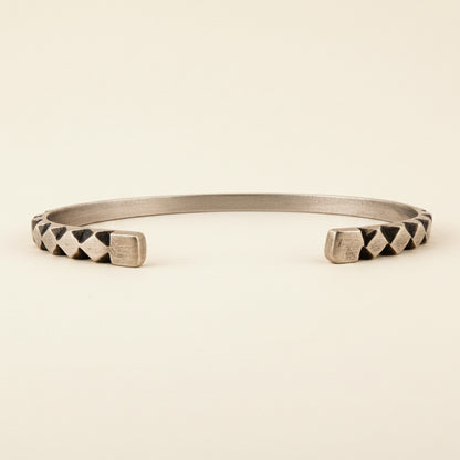 Hand-carved diamond pattern cuff bracelet, silver-toned with black geometric inlays