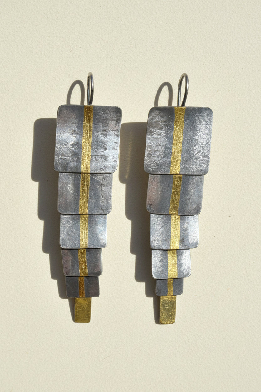 Longitude earrings with stacked silver-gray rectangles and gold vertical accents