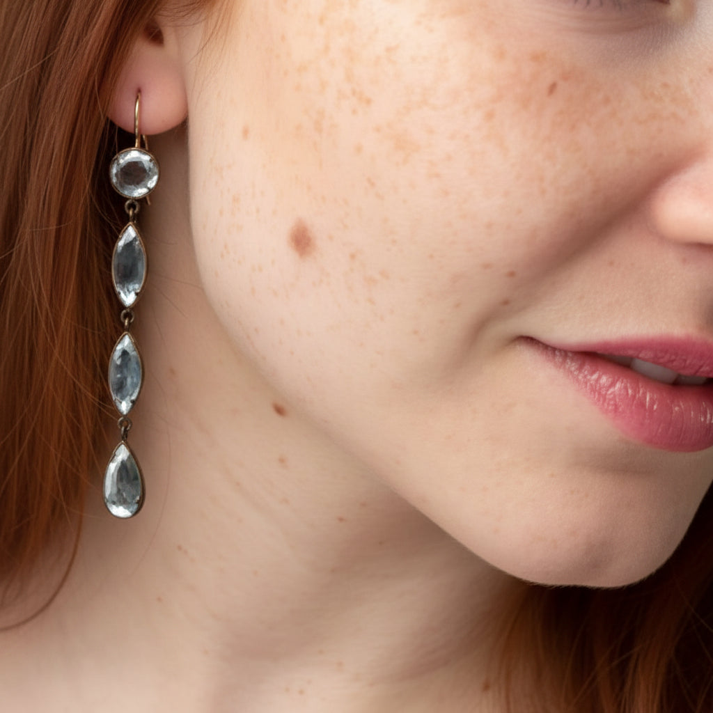 Long drop earrings with mirrored beveled teardrop charms and silver-tone hooks