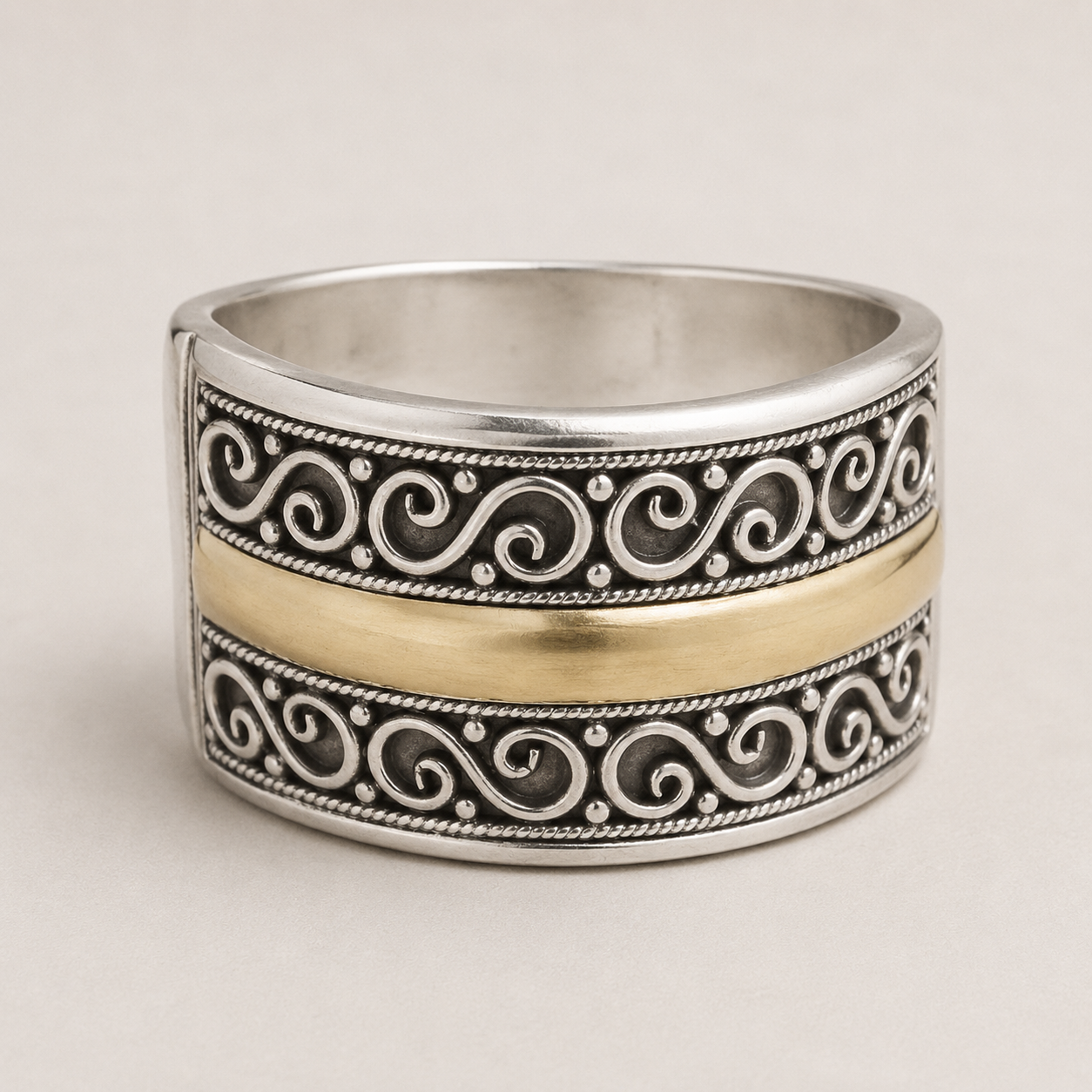 Two-tone filigree band ring with engraved scroll pattern, silver and gold-tone