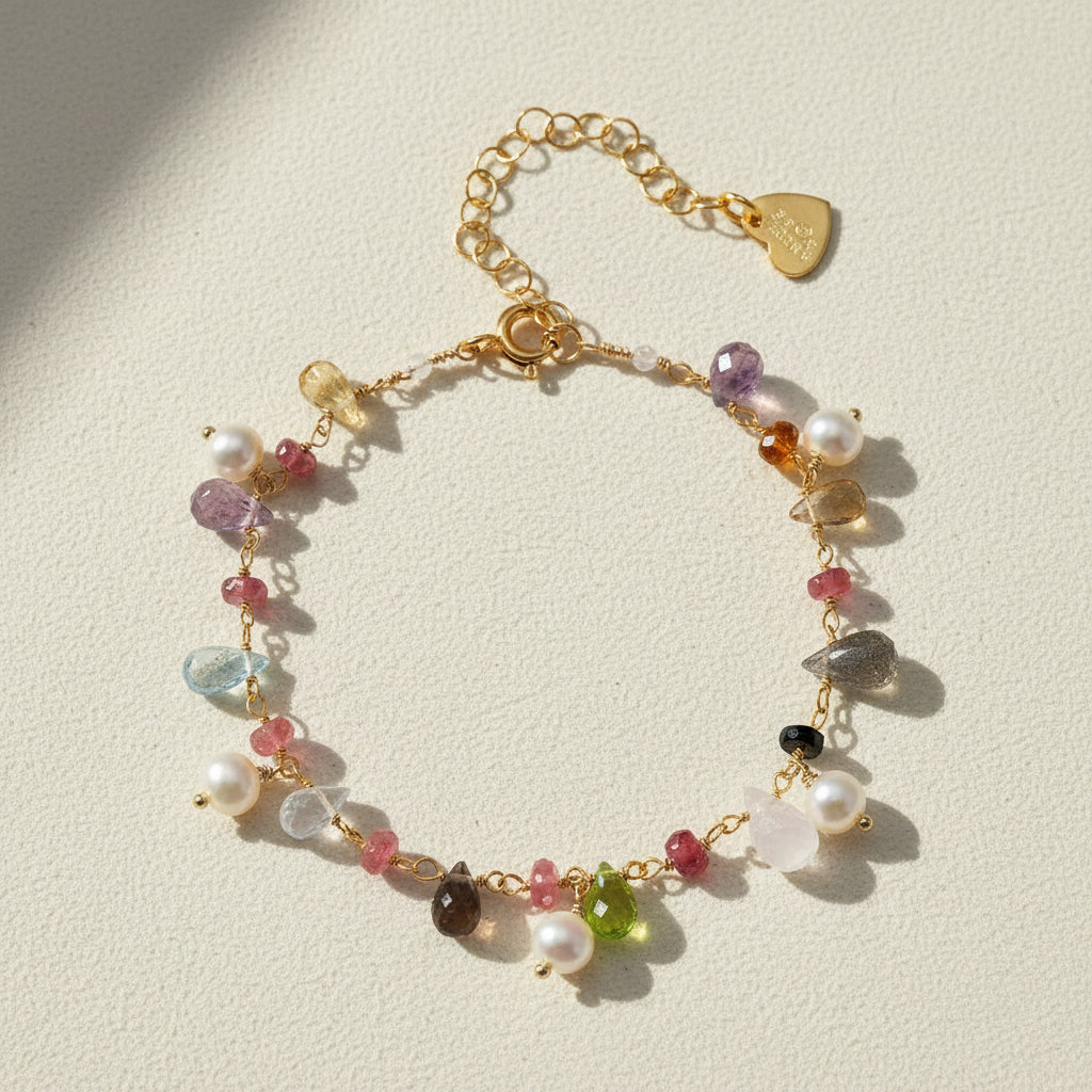 Gold-tone bracelet with freshwater pearls, multicolor gemstones, and heart clasp charm