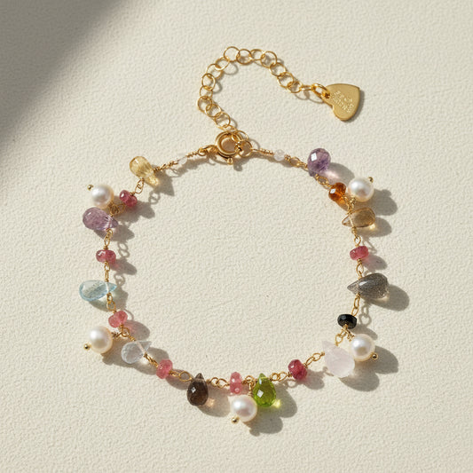 Gold-tone bracelet with freshwater pearls, multicolor gemstones, and heart clasp charm