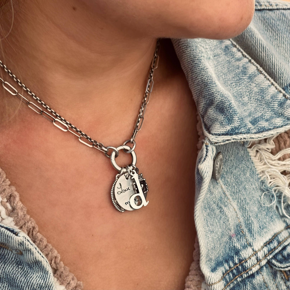 Silver-tone double chain necklace with hammered ring and charm pendant