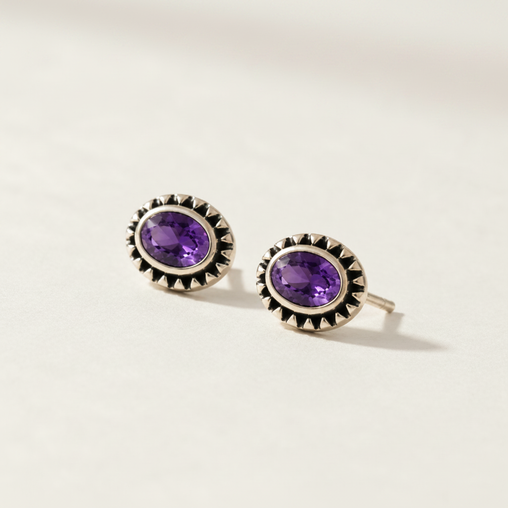 Gemstone stud earrings with purple oval center and silver beaded halo