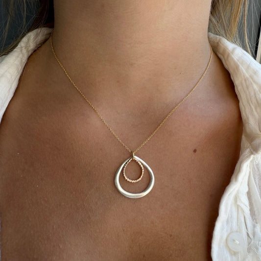 Two-tone double drop necklace with layered teardrop pendant in gold and silver with brown center