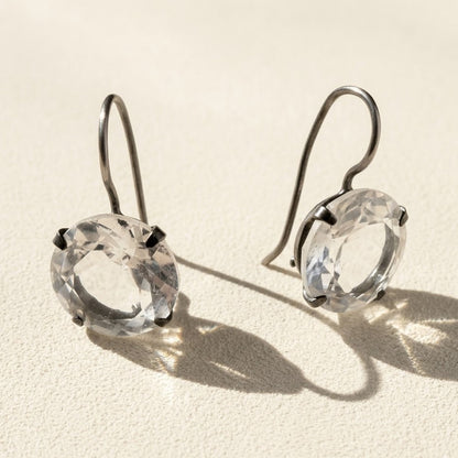 Silver-tone drop earrings with round faceted clear stone in prong setting