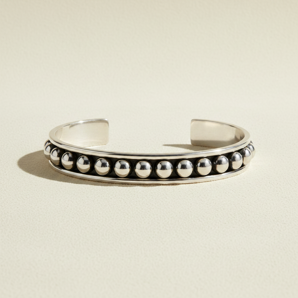 Silver-tone cuff bracelet with round black and white beaded row accents