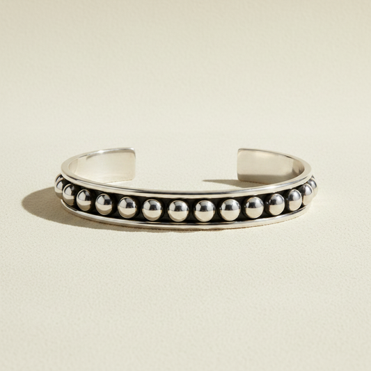 Silver-tone cuff bracelet with round black and white beaded row accents