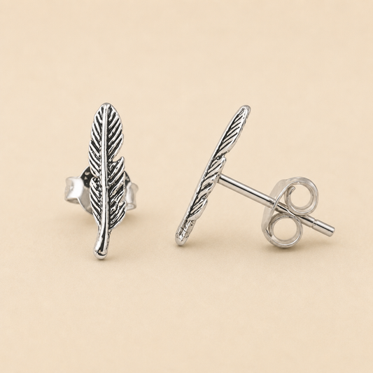 Silver-tone feather stud earrings with vertical leaf pattern, round post back