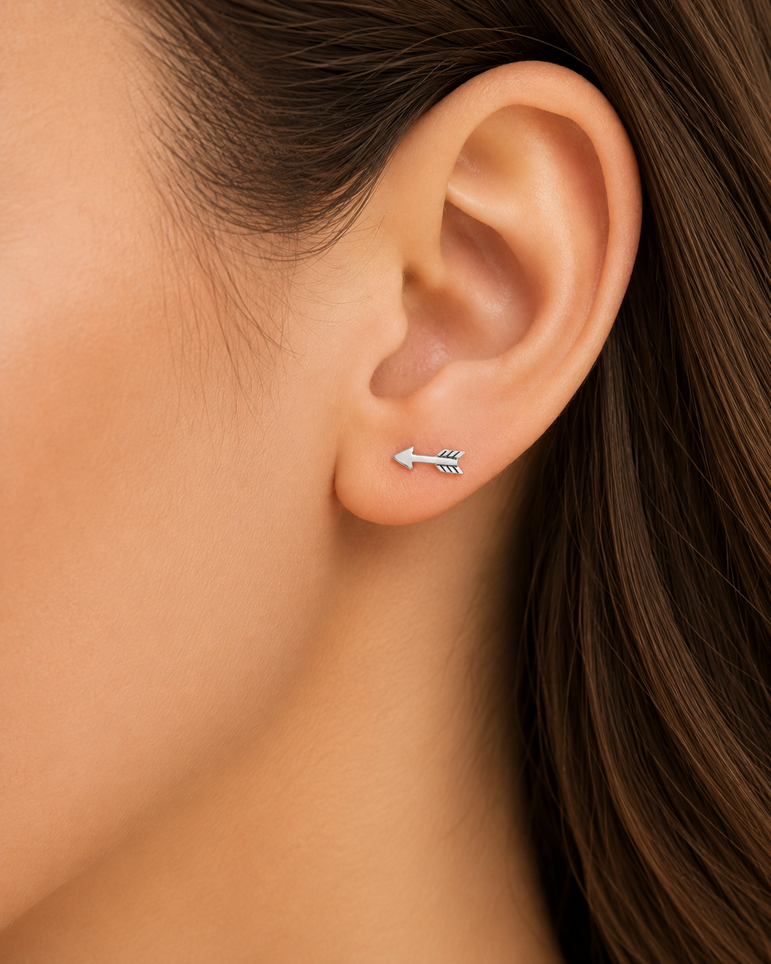 Arrow stud earrings, silver-toned arrow with black inlay stripe details, on ear