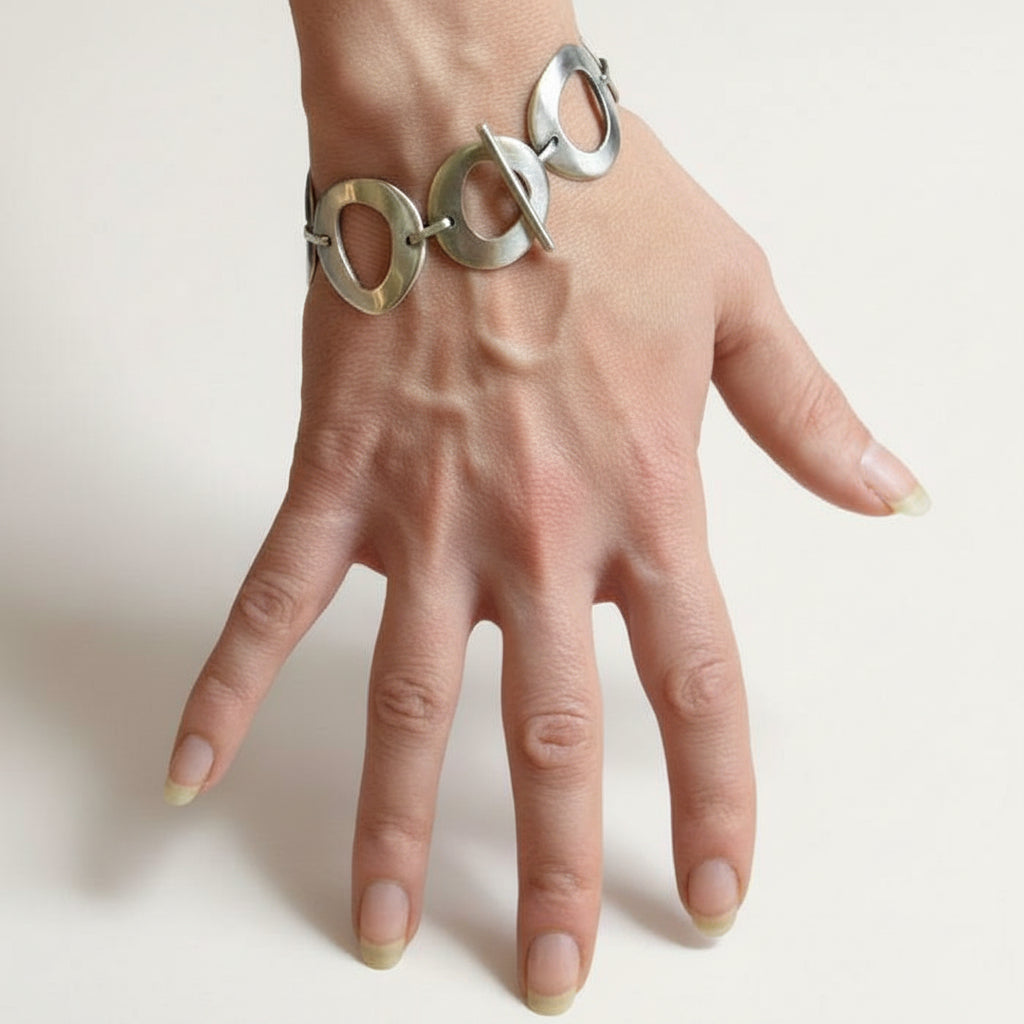 Silver circle link bracelet with organic cutout links on wrist