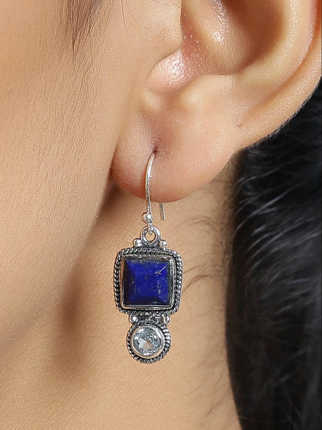 Silver-tone dangle earring with blue square gemstone and round crystal below