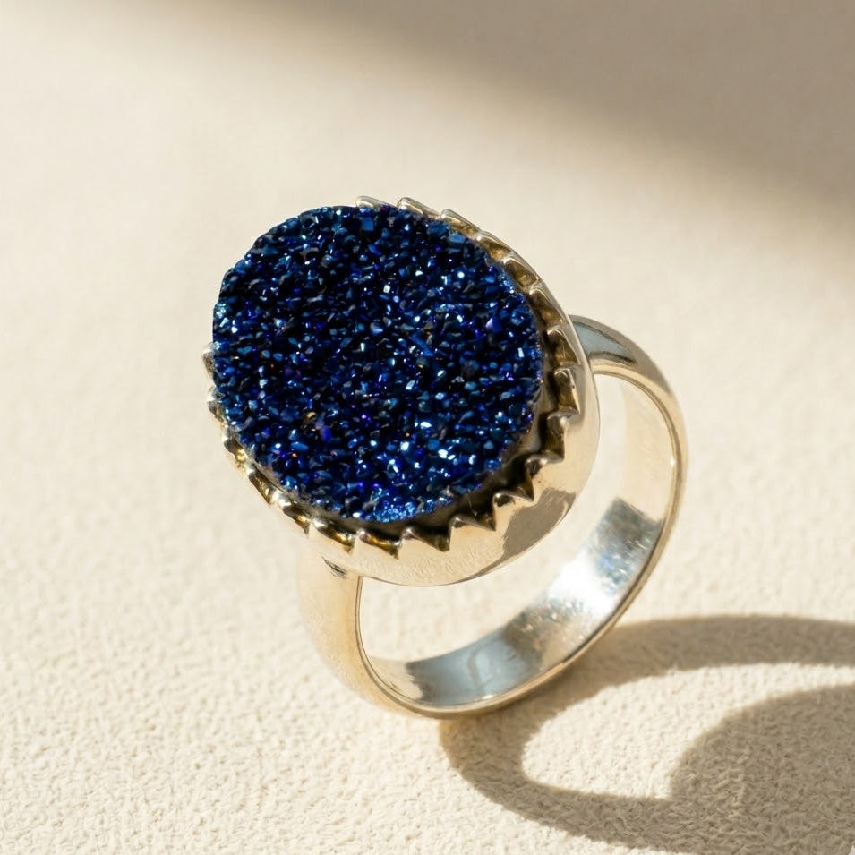 Large oval druzy ring with deep blue glitter stone in gold-tone setting