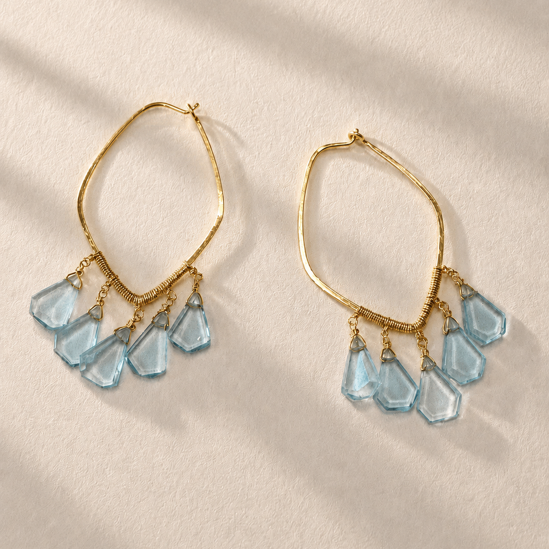 Aquamarine slice hoop earrings with faceted blue charms and gold-tone hooks