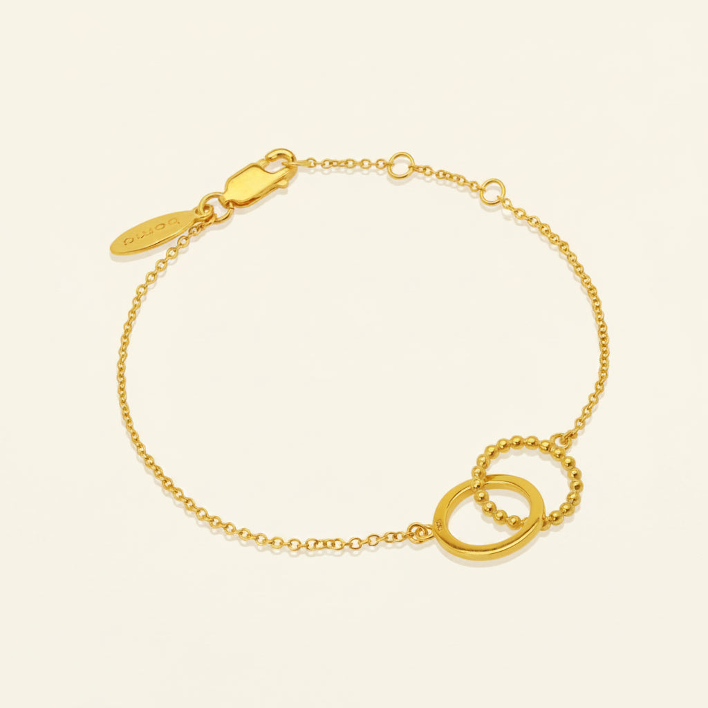 Gold bracelet with a clasp on a white background