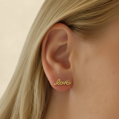 Gold Love script stud earrings, small cursive “Love” on posts