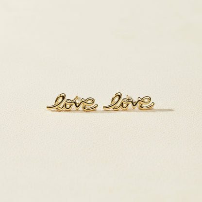 Gold Love script stud earrings, pair laid flat