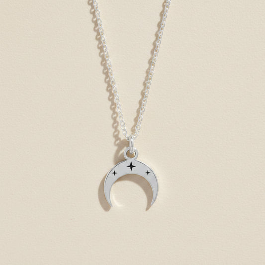Silver-tone crescent moon necklace with star accents on a linked chain