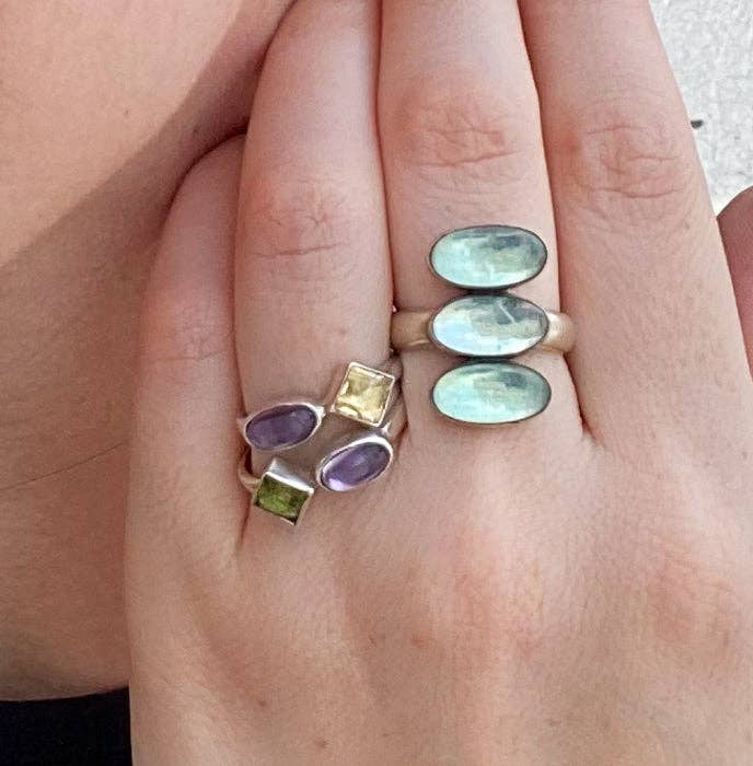 Double stone stacking ring with two oval opal-like light green stones on silver band