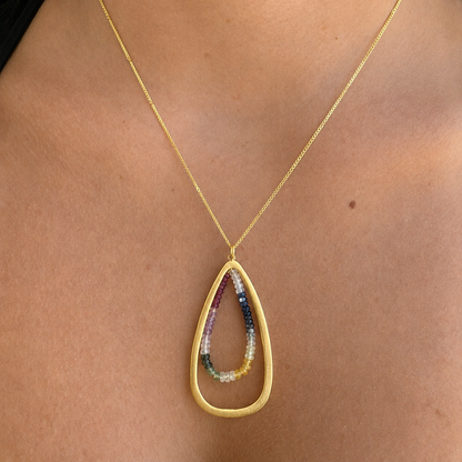 Teardrop sapphire bead pendant necklace with gold chain, worn