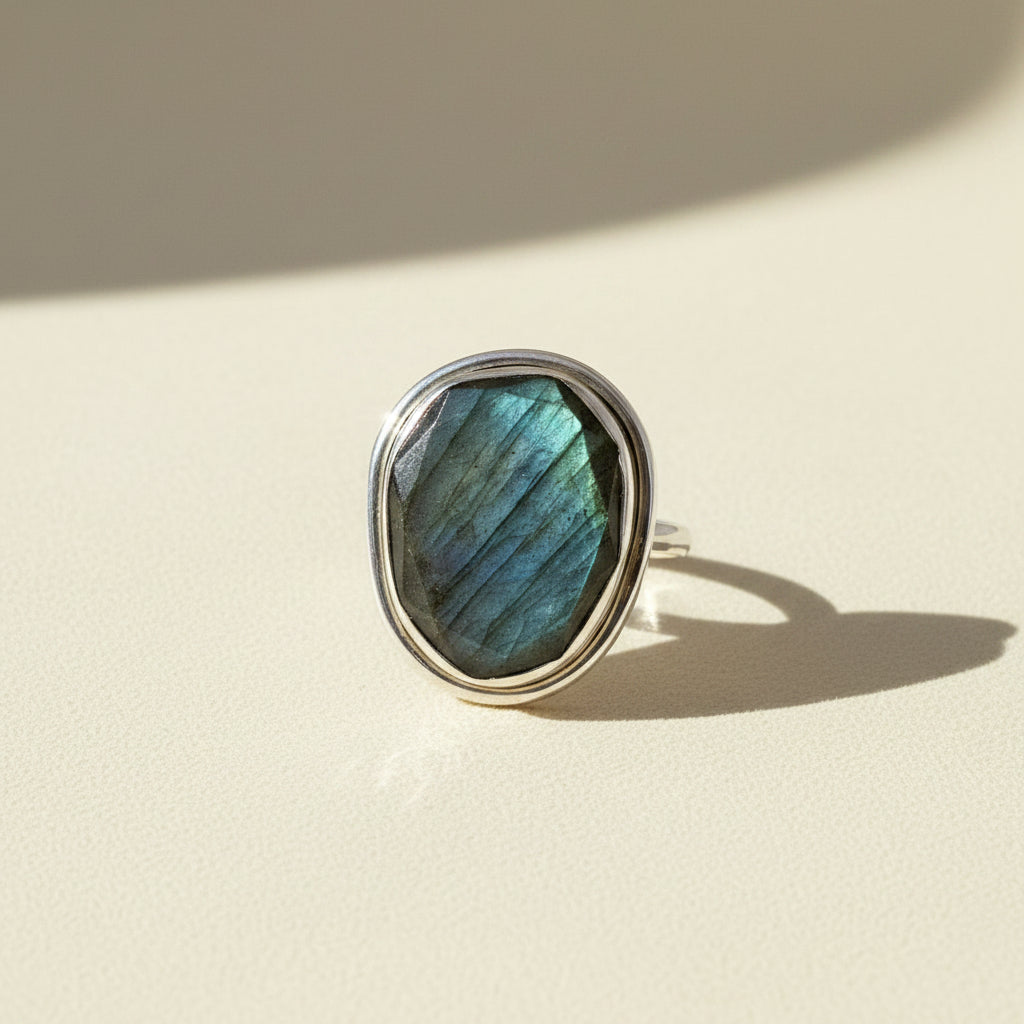 Sterling silver ring with large oval labradorite gemstone, blue-green iridescence bezel