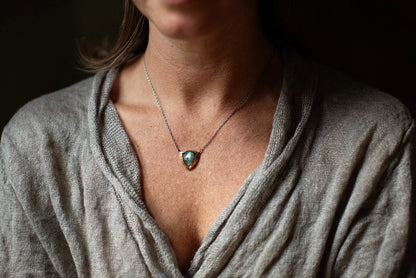 Gold-tone pendant necklace with blue teardrop stone on delicate chain