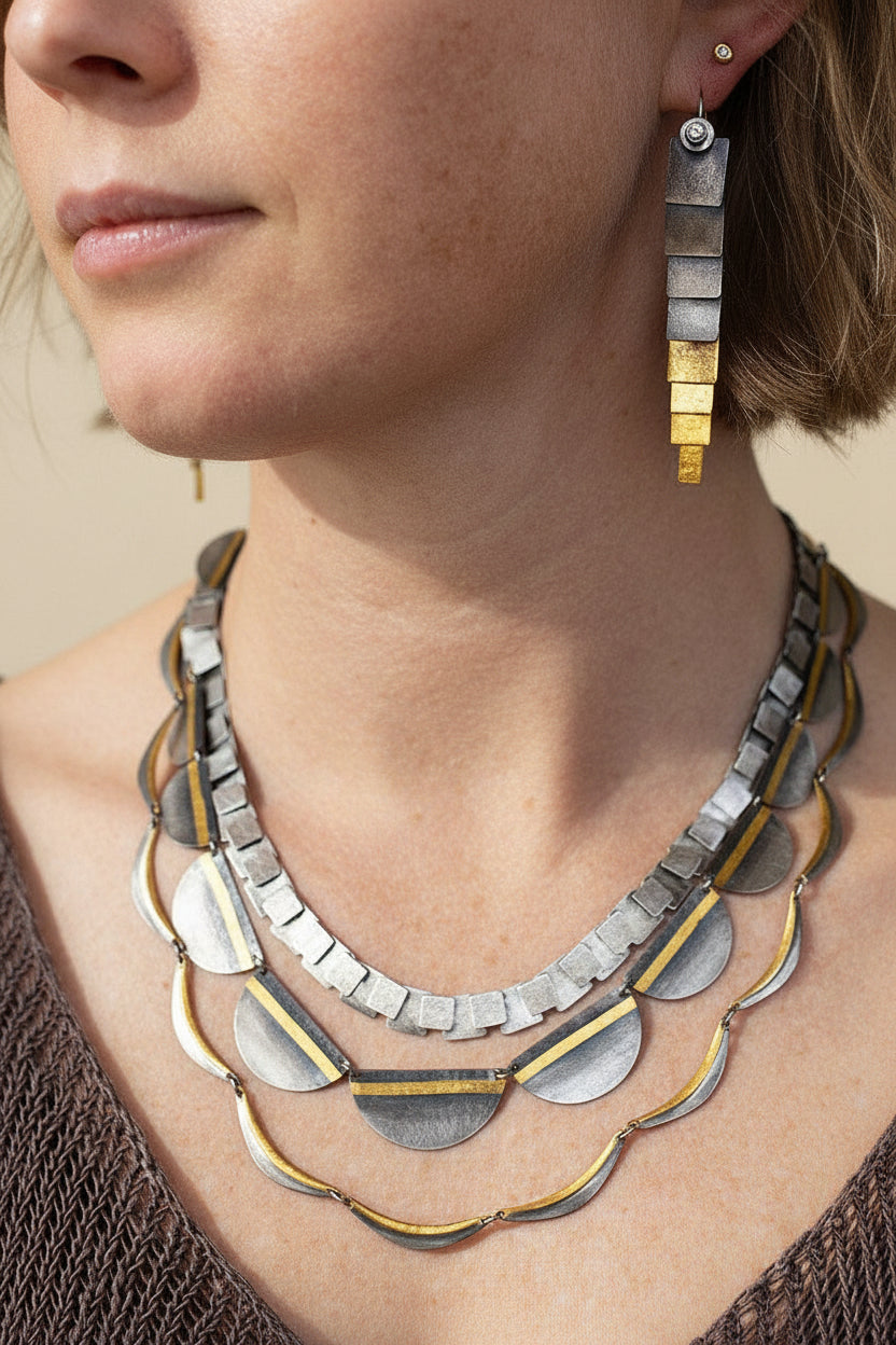 Two-tone drop earrings with stacked rectangles, silver top and gold lower bars.