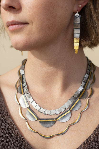 Two-tone drop earrings with stacked rectangles, silver top and gold lower bars.
