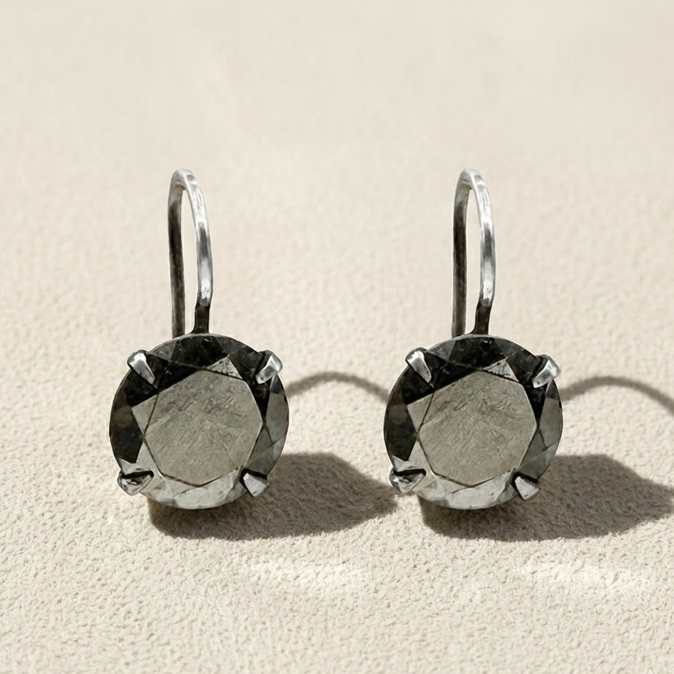 Silver-tone drop earrings with round faceted dark stone in prong setting