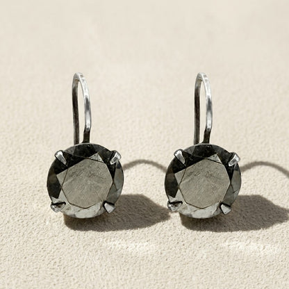 Silver-tone drop earrings with round faceted dark stone in prong setting