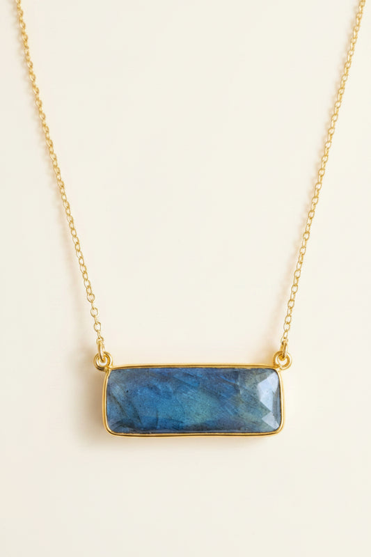 Necklace with a blue stone pendant on a white background